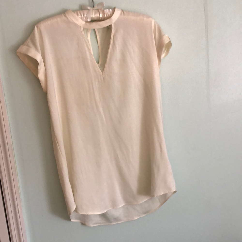 Off White-cream Blouse. 96% Polyester 4% Spandex. Small button closure in back.